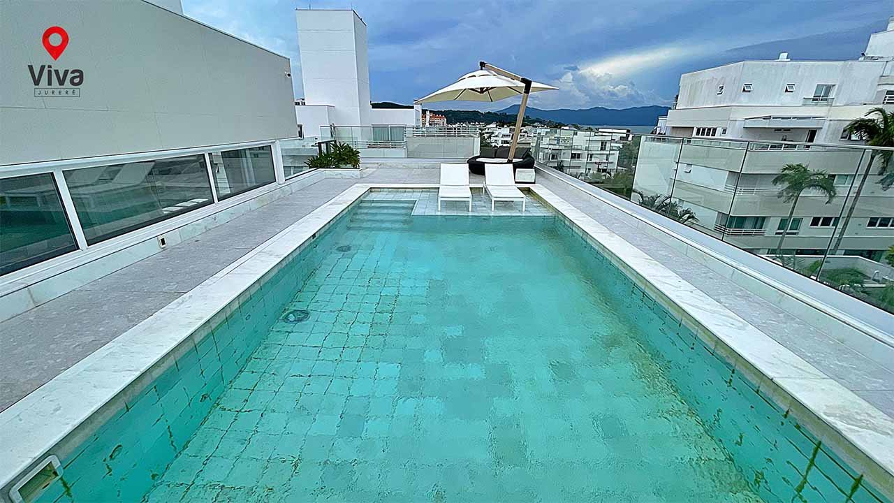 Piscina privativa na cobertura, espreguiçadeiras e vista panorâmica para o litoral de Jurerê Internacional.